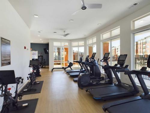 Apartments in for rent Farragut TN A modern gym with treadmills, stationary bikes, and large windows allowing natural light. Anchor 934 Apartments in Biddle Farms Town Center